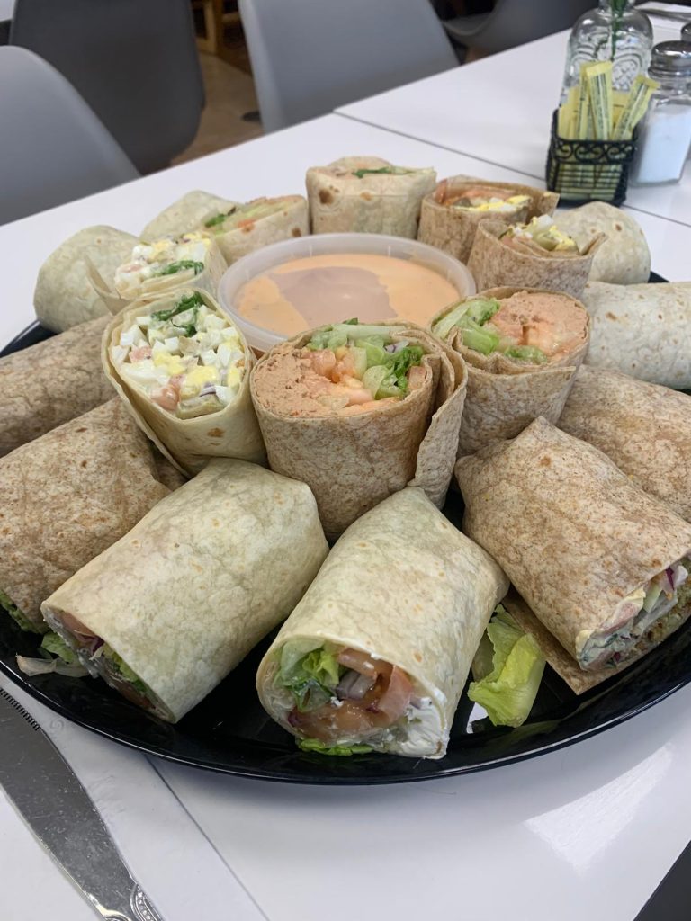 Panini Cafe catering buffet in Lakewood, NJ with wrap platters, salads and hot trays